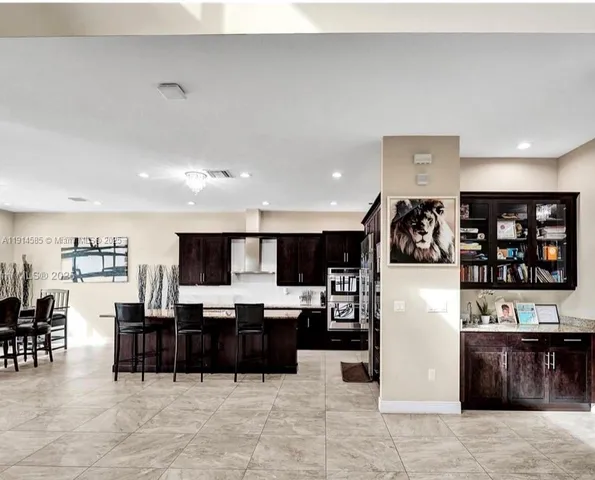 a living room with lots of furniture and kitchen view