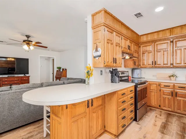 a kitchen with stainless steel appliances granite countertop a sink and a refrigerator