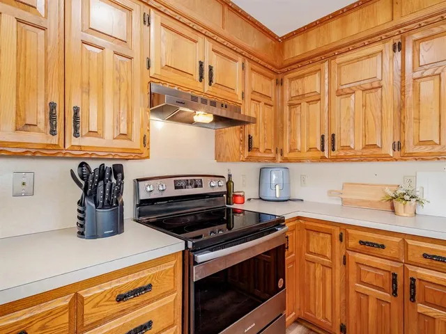 a kitchen with stainless steel appliances granite countertop a stove and a sink