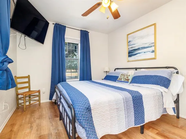 a bedroom with a bed and a flat screen tv