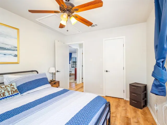 a bedroom with a bed and a chandelier