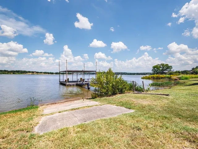 a view of a lake with a yard