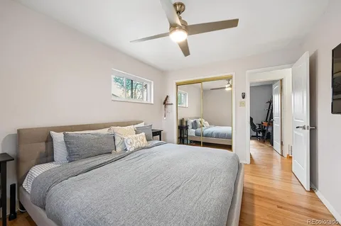 a bedroom with a large bed and a chandelier