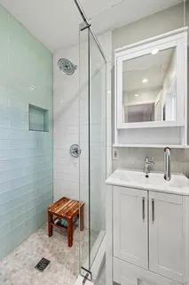 a bathroom with a sink toilet and shower