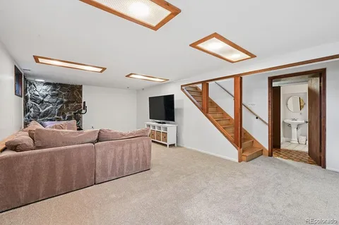a living room with furniture and a ceiling fan