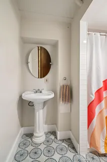 a bathroom with a sink toilet and mirror