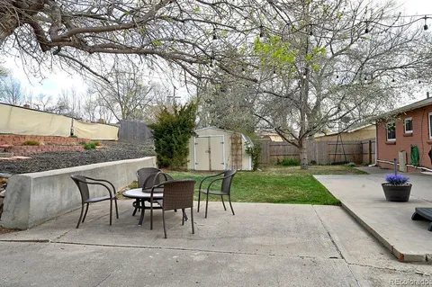 a view of a patio with a table and chairs and couches