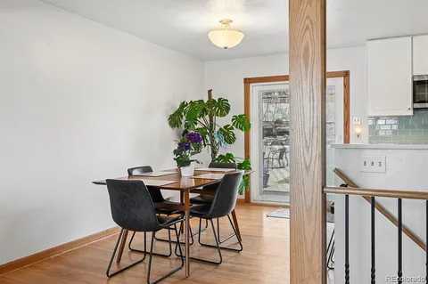 a view of a dining room with furniture and a potted plant