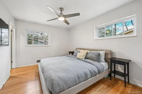 a bedroom with a bed and wooden floor