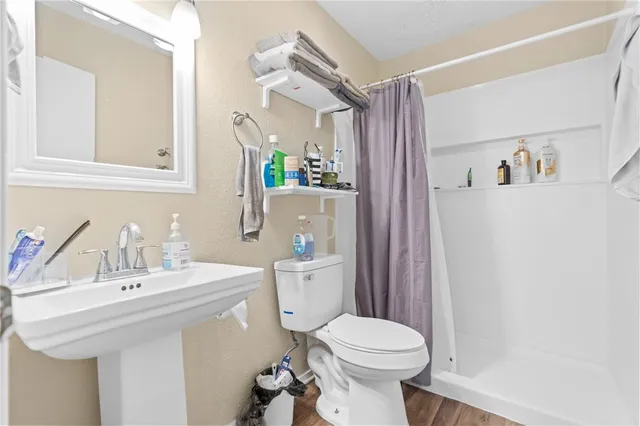 a bathroom with a sink toilet and shower