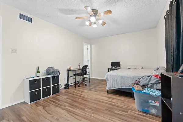 a bedroom with a bed and a desk in it