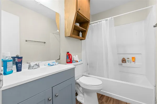a bathroom with a sink vanity mirror and toilet