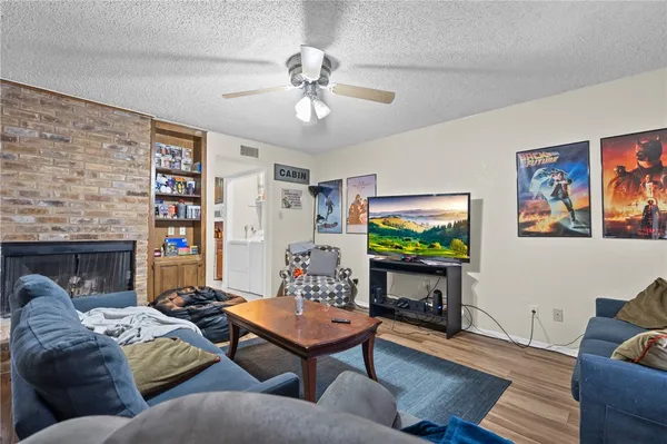 a living room with furniture a rug and a flat screen tv
