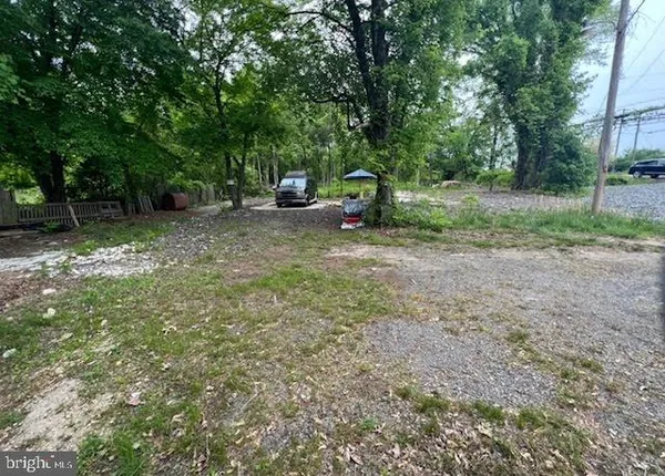 a view of backyard with outdoor and green space