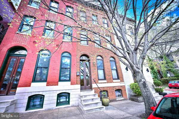 a front view of multi story residential apartment building with yard