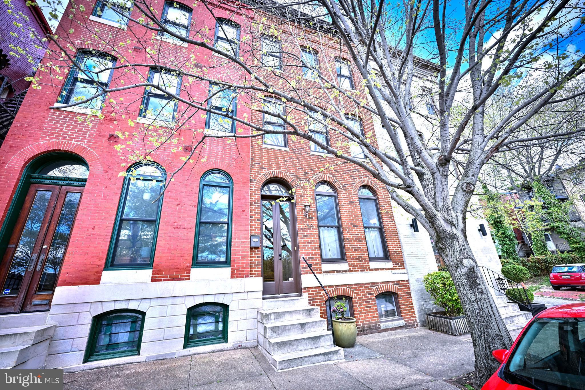 a front view of multi story residential apartment building with yard