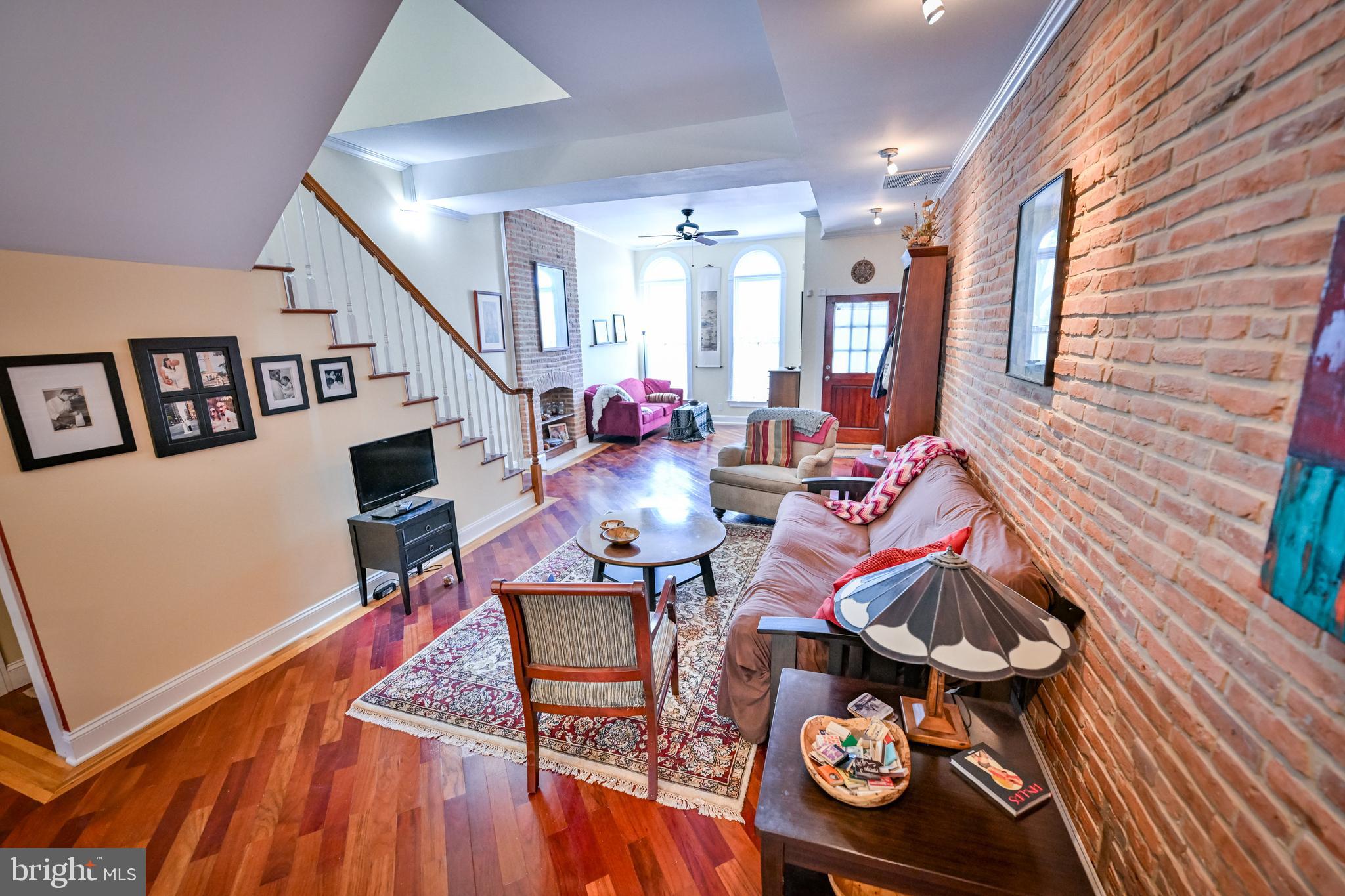240 Wilson Street Baltimore, MD 21217 - Photo 14 of 63 a living room with furniture and a wooden floor