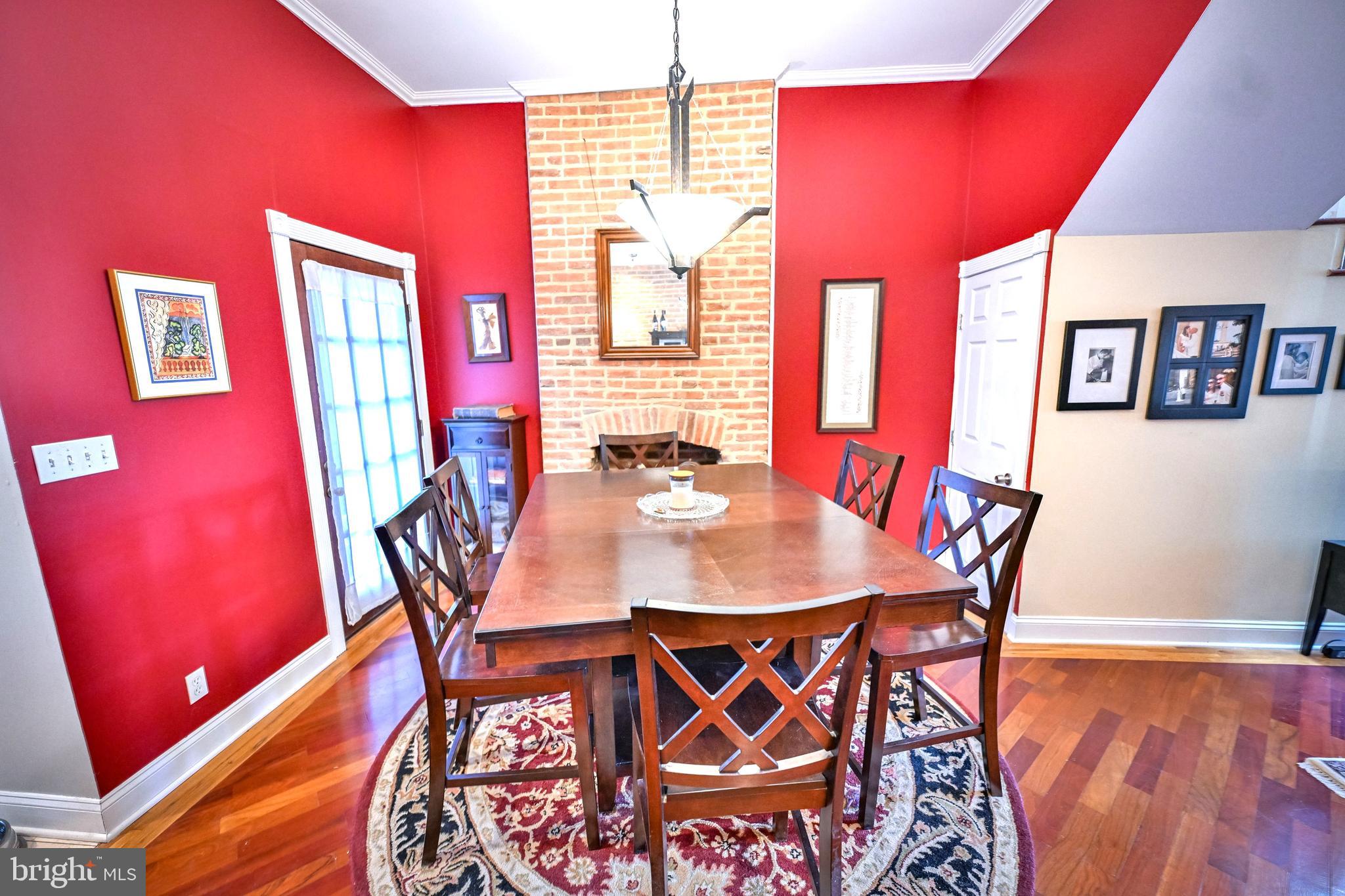 240 Wilson Street Baltimore, MD 21217 - Photo 17 of 63 a view of a dining room with furniture and wooden floor
