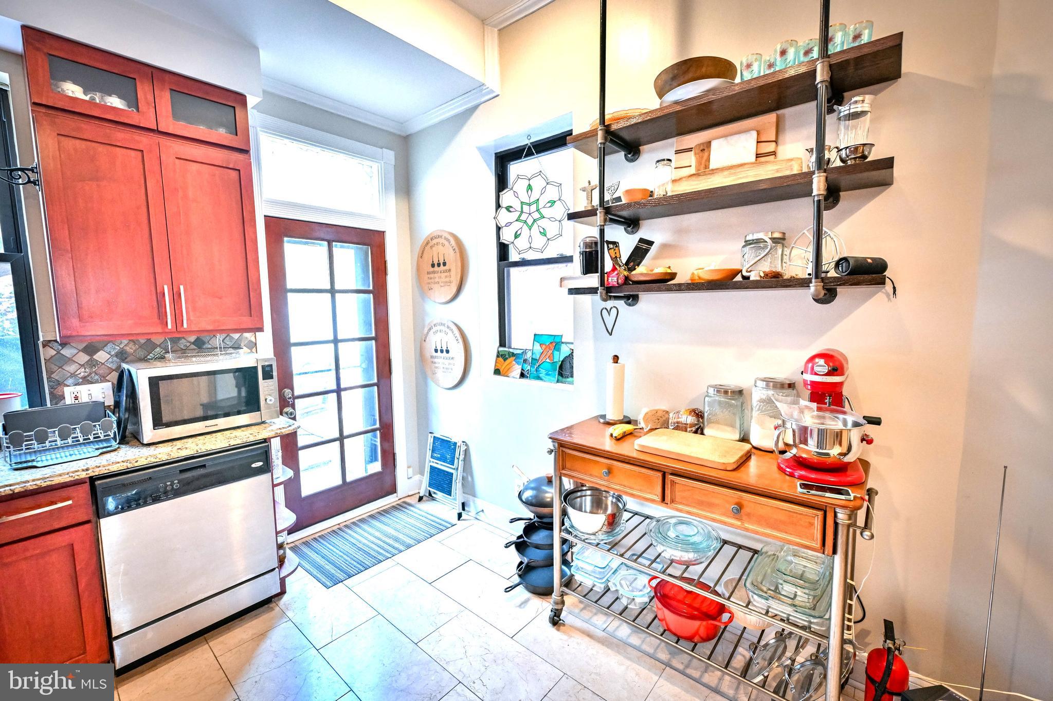 240 Wilson Street Baltimore, MD 21217 - Photo 23 of 63 a utility room with stainless steel appliances cabinet and a window