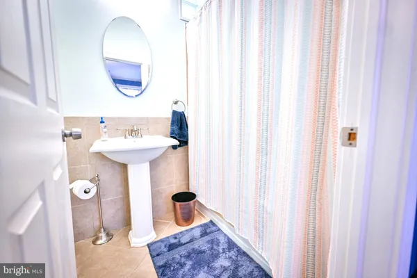 a view of a balcony with wooden floor and a sink