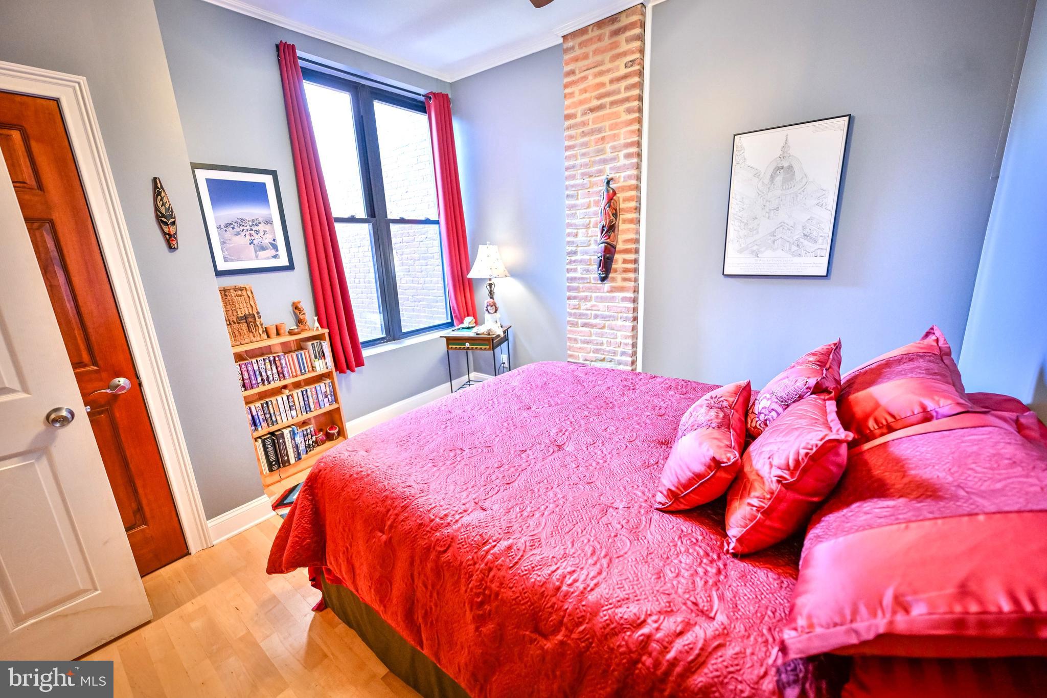 240 Wilson Street Baltimore, MD 21217 - Photo 34 of 63 a bedroom with a bed and a large window