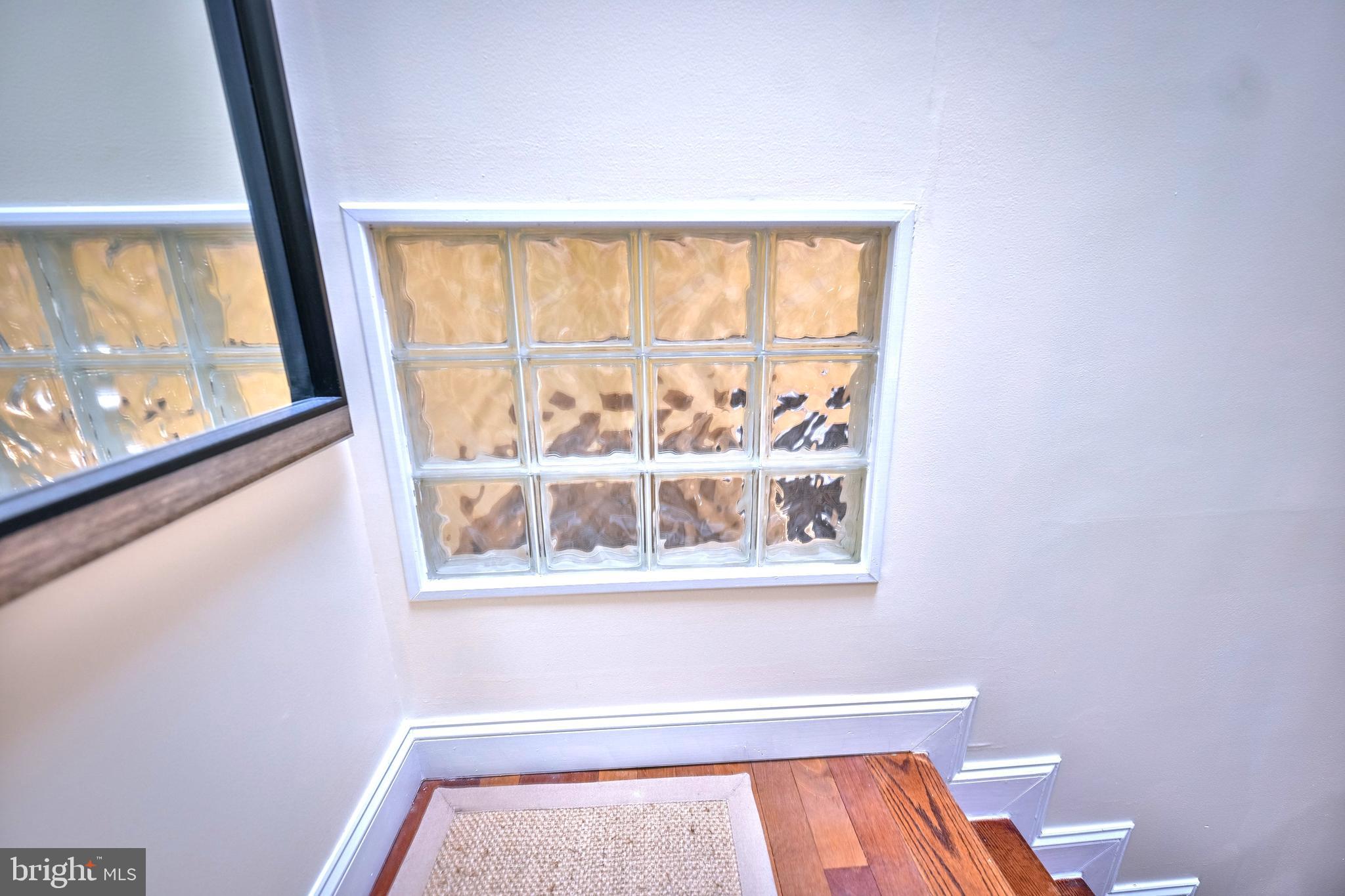 240 Wilson Street Baltimore, MD 21217 - Photo 40 of 63 a view of an empty room with wooden floor and a window