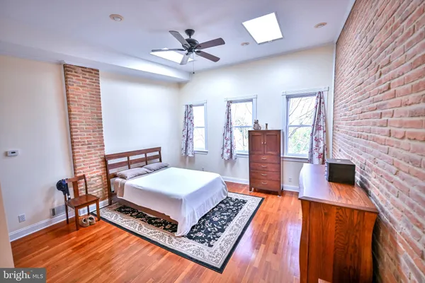 a bedroom with furniture and a rug