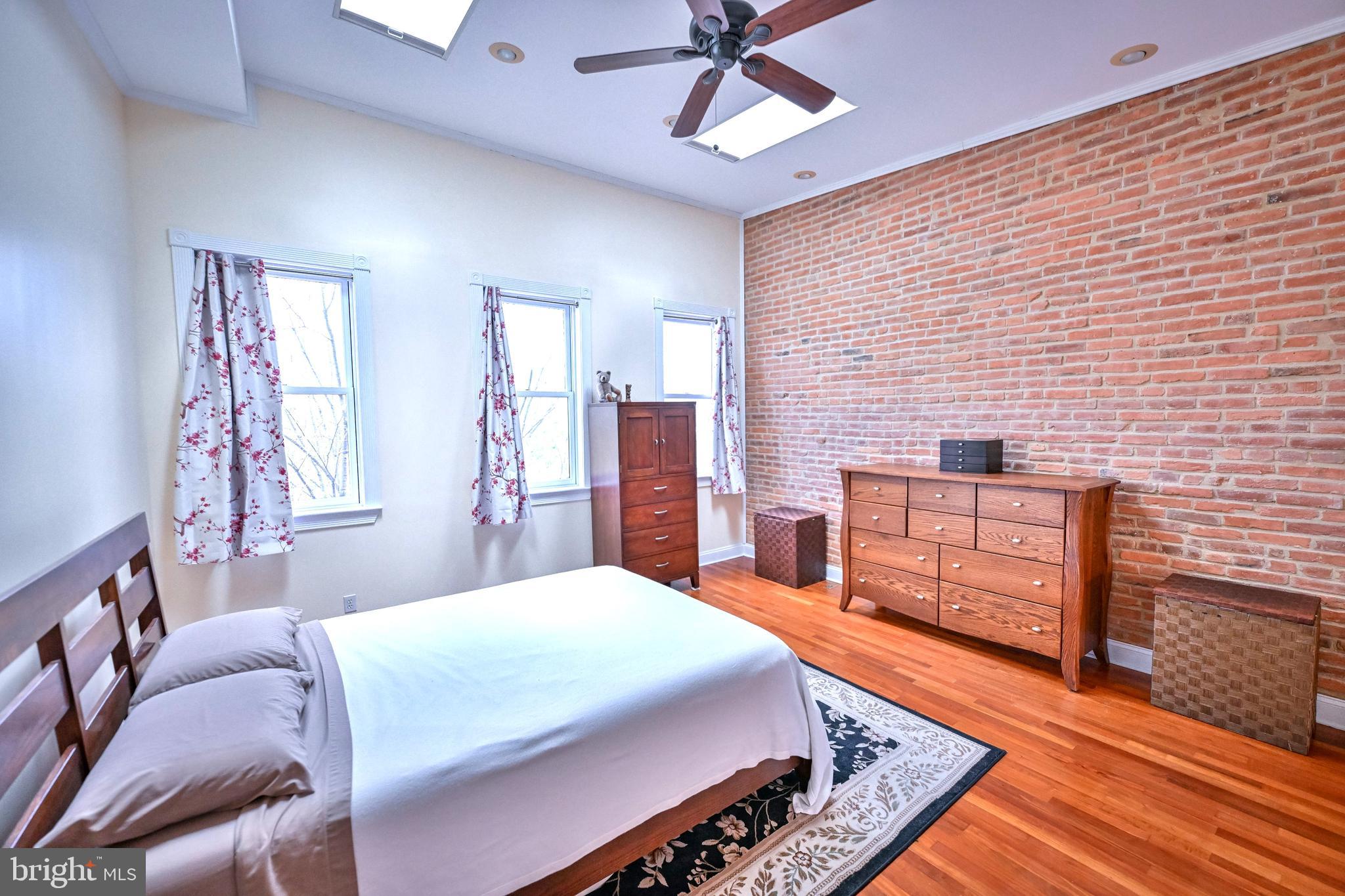 240 Wilson Street Baltimore, MD 21217 - Photo 47 of 63 a bedroom with a bed and a dresser