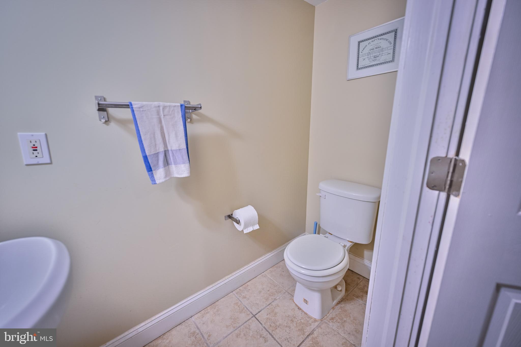 240 Wilson Street Baltimore, MD 21217 - Photo 58 of 63 a white toilet sitting next to a shower curtain