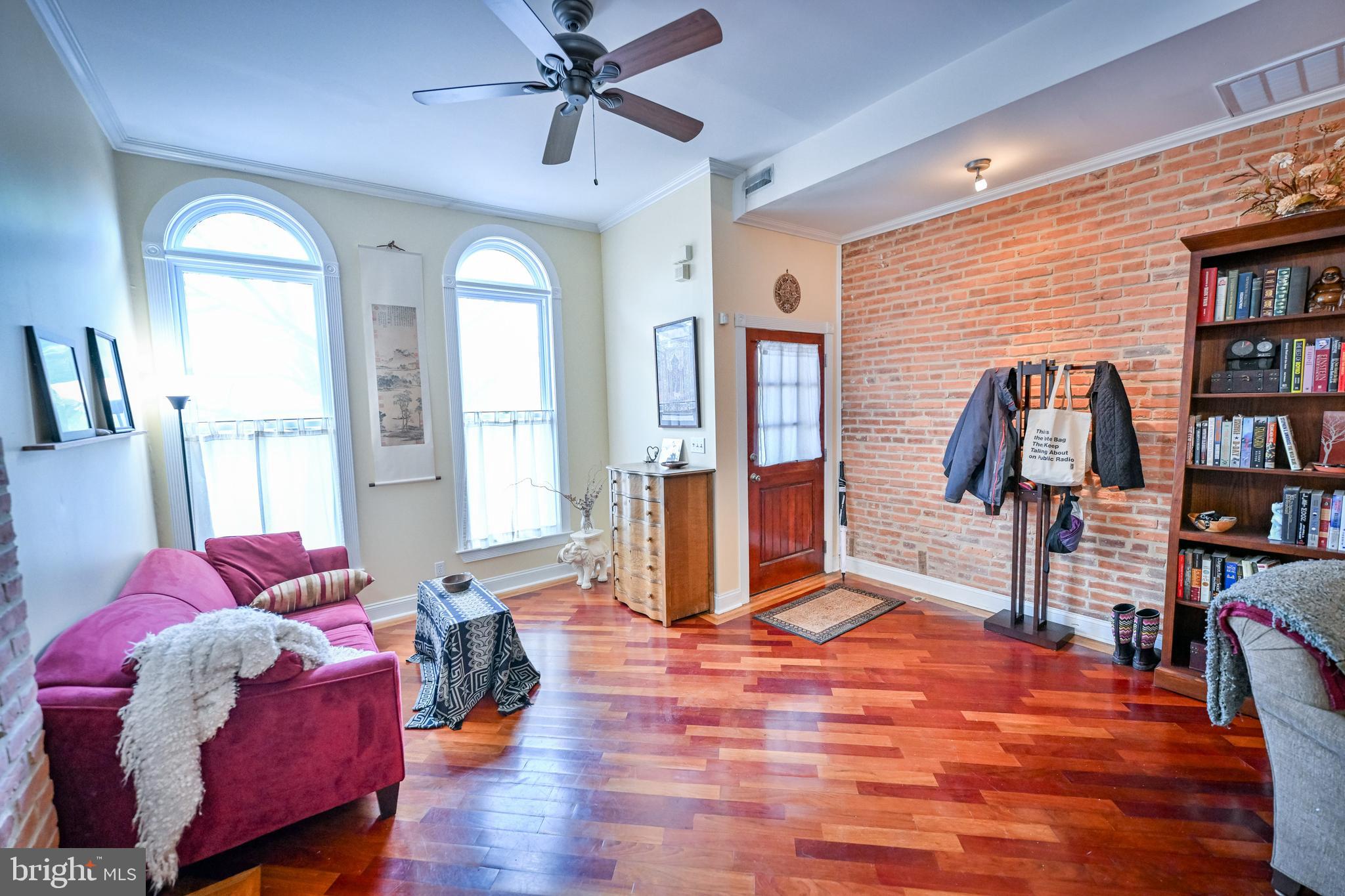 240 Wilson Street Baltimore, MD 21217 - Photo 8 of 63 Living room w/ HW FL & brick accent wall