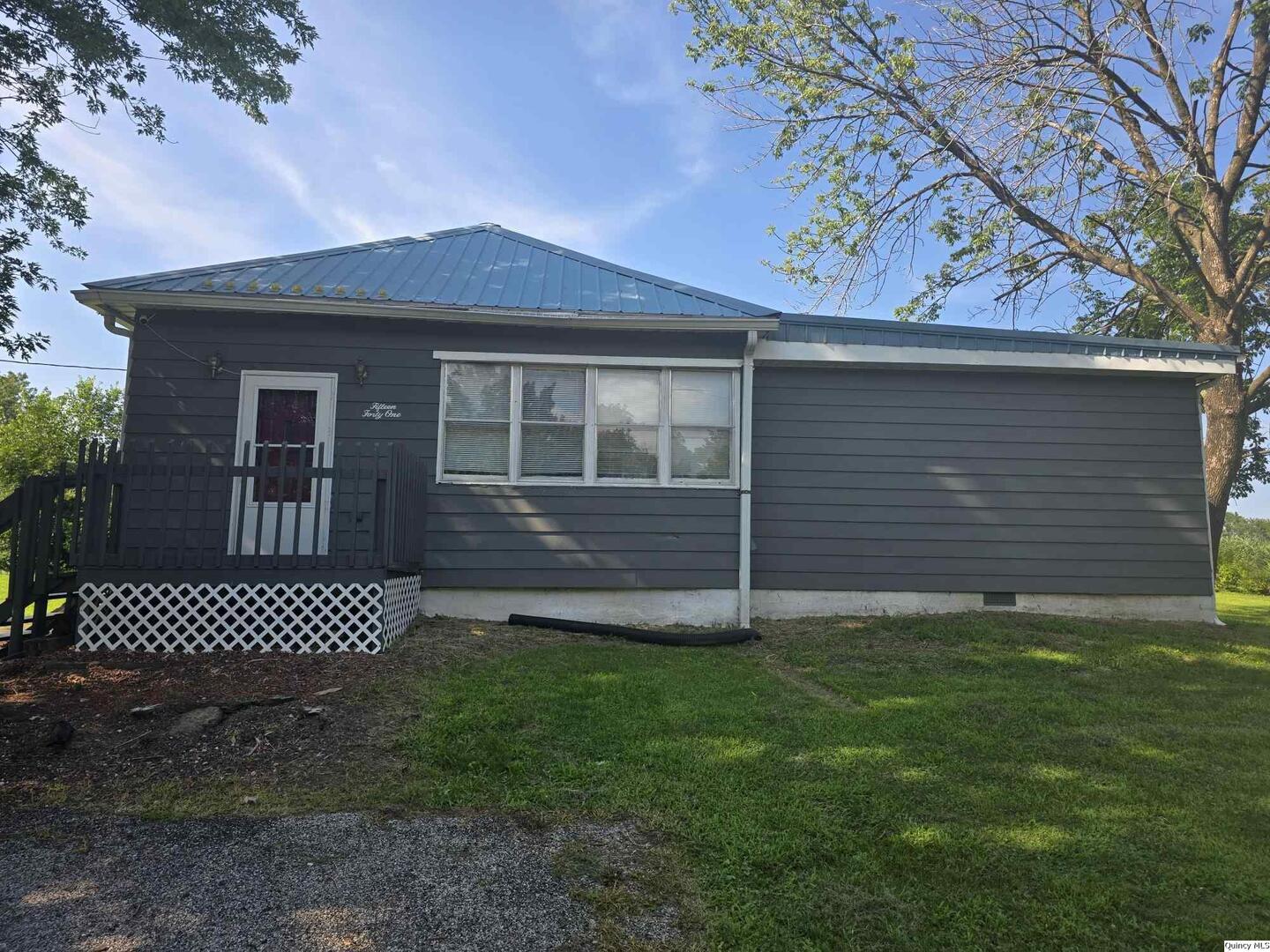 1541 Elm Street Hamilton, IL 62341 - Photo 1 of 31 a front view of a house with a garden