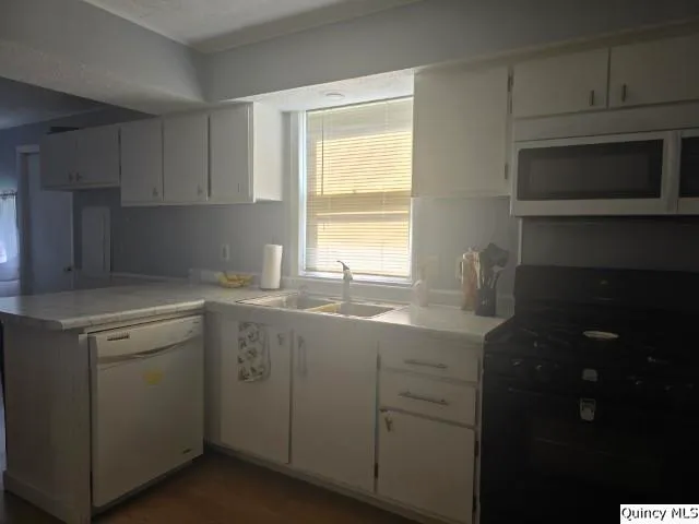 a room with a refrigerator and ceiling fan