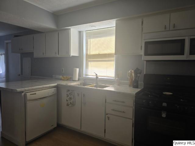 1541 Elm Street Hamilton, IL 62341 - Photo 11 of 31 a kitchen with a sink stove and microwave