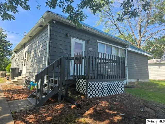 a view of backyard with a garden and deck