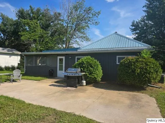 a front view of a house with garden and patio