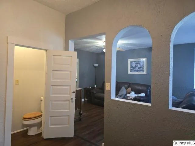 a white toilet sitting next to a bath tub