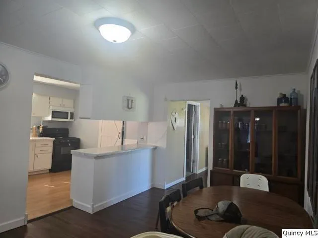 view of a room with wooden floor and windows