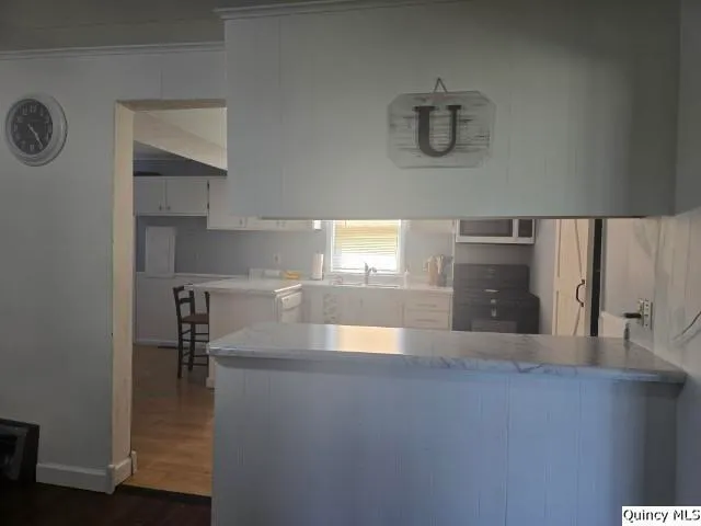 a kitchen with a sink a stove and cabinets