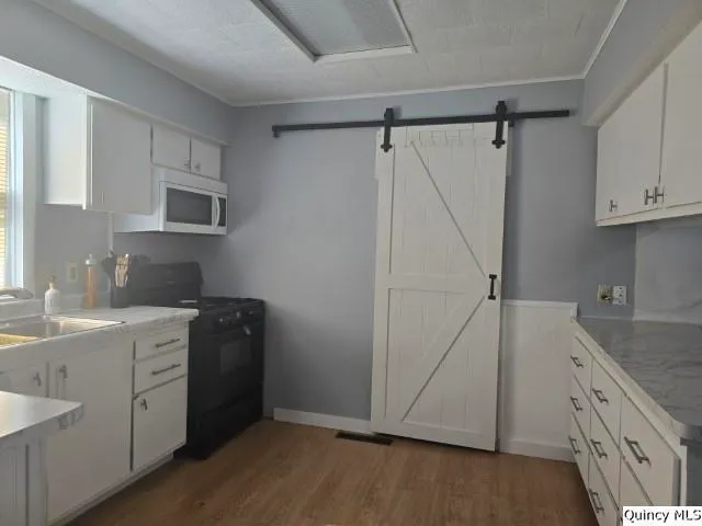 a kitchen with a sink stove and microwave