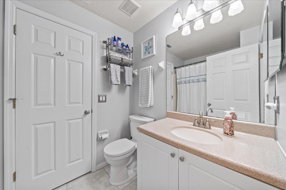 750 Luminary Circle, Unit 103 Melbourne, FL 32901 - Photo 12 of 39 a bathroom with a sink a toilet and shower