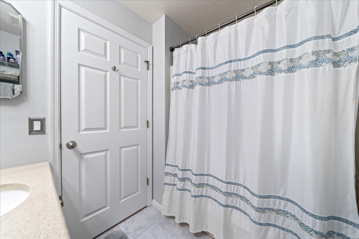750 Luminary Circle, Unit 103 Melbourne, FL 32901 - Photo 13 of 39 a bathroom with a sink and a shower curtain