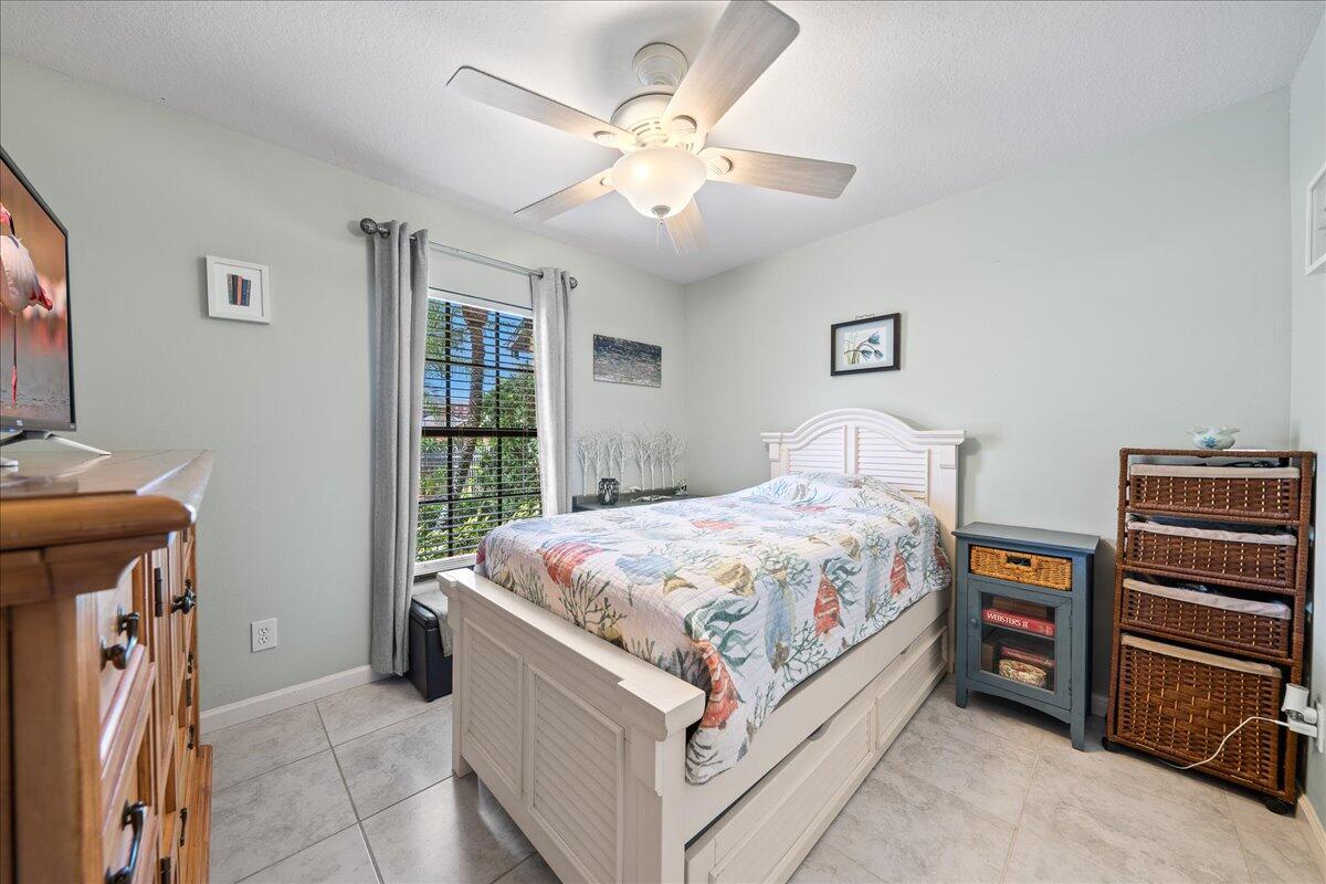 750 Luminary Circle, Unit 103 Melbourne, FL 32901 - Photo 14 of 39 a spacious bedroom with a bed and a chandelier