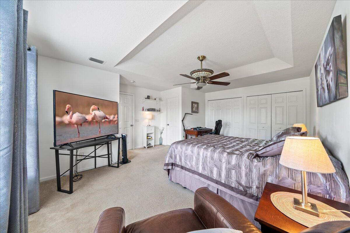 750 Luminary Circle, Unit 103 Melbourne, FL 32901 - Photo 15 of 39 a bedroom with a bed and a flat screen tv