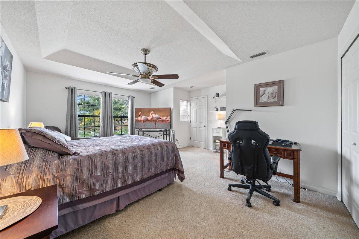 750 Luminary Circle, Unit 103 Melbourne, FL 32901 - Photo 16 of 39 a bed room with a bed and a desk