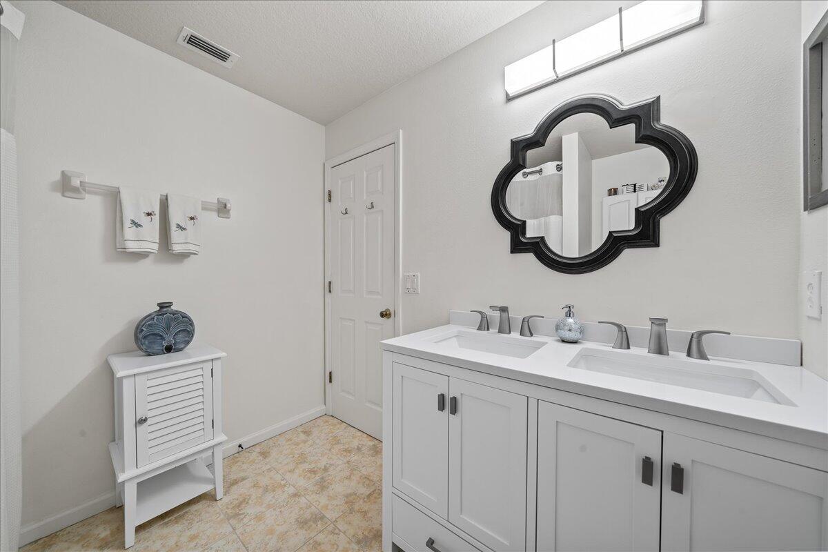 750 Luminary Circle, Unit 103 Melbourne, FL 32901 - Photo 17 of 39 a bathroom with a sink and a mirror