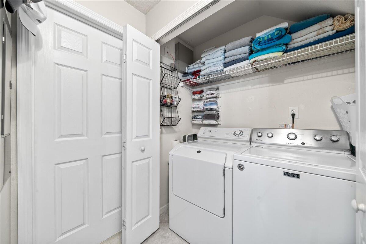 750 Luminary Circle, Unit 103 Melbourne, FL 32901 - Photo 19 of 39 a view of storage and utility room with washer and dryer