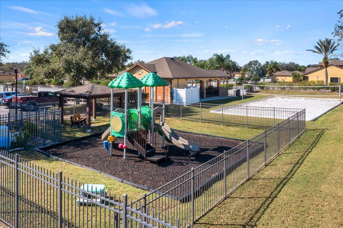 750 Luminary Circle, Unit 103 Melbourne, FL 32901 - Photo 35 of 39 a view of a swimming pool with a lounge chair and palm trees