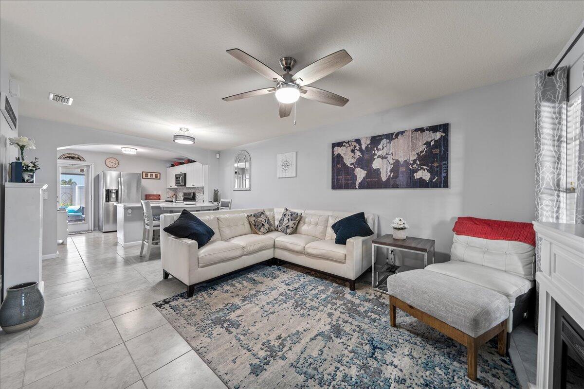 750 Luminary Circle, Unit 103 Melbourne, FL 32901 - Photo 5 of 39 a living room with furniture and a chandelier