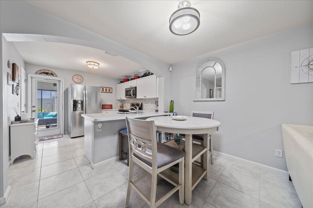 750 Luminary Circle, Unit 103 Melbourne, FL 32901 - Photo 6 of 39 a view of kitchen with cabinets and window