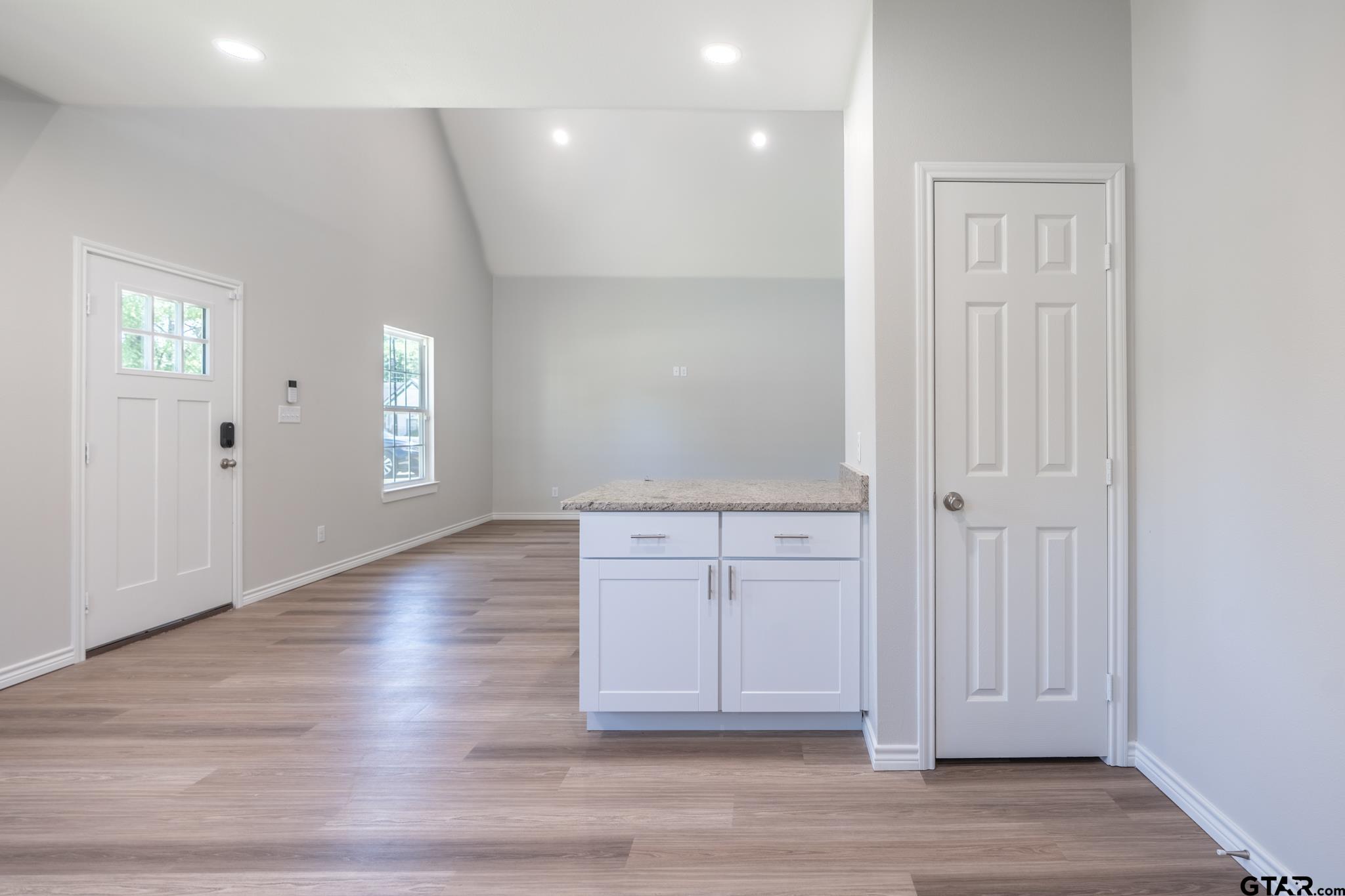 233 Harrison Street Longview, TX 75601 - Photo 15 of 44 an empty room with wooden floor and windows